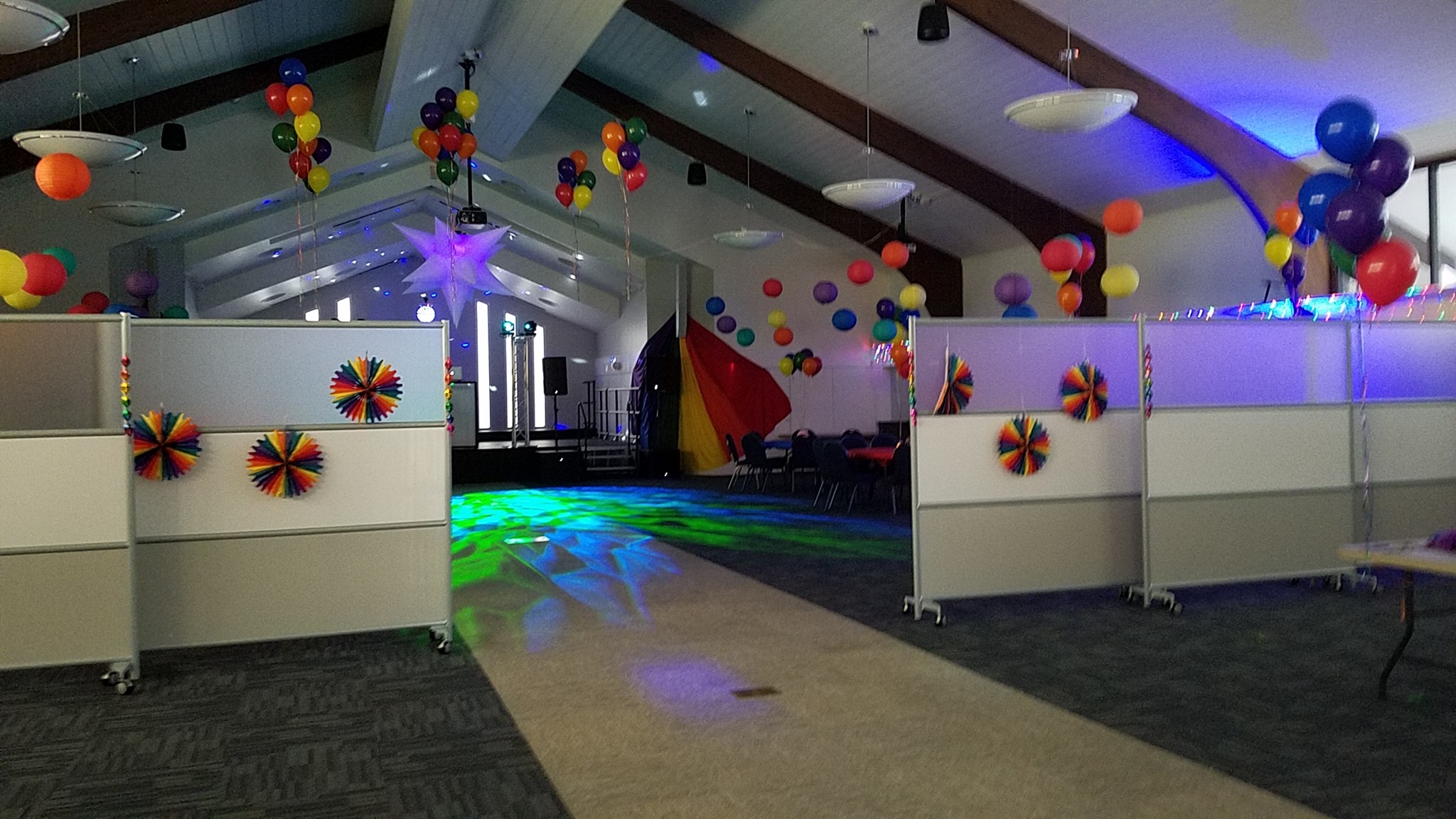 Open room with pride decorations and dim lighting 