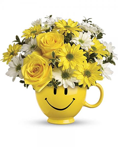 Teleflora's "Be Happy" Bouquet with Yellow Roses. When you're looking to make someone smile, this happy face mug of roses and daisies is tops. Sure to cheer up everyone from a beloved wife to a busy boss, these are also great flowers for kids. Yellow roses and daisy spray chrysanthemums along with white daisy spray chrysanthemums and oregonia are delivered in Teleflora's one and only yellow happy face, Be Happy® mug. Orientation: One-Sided