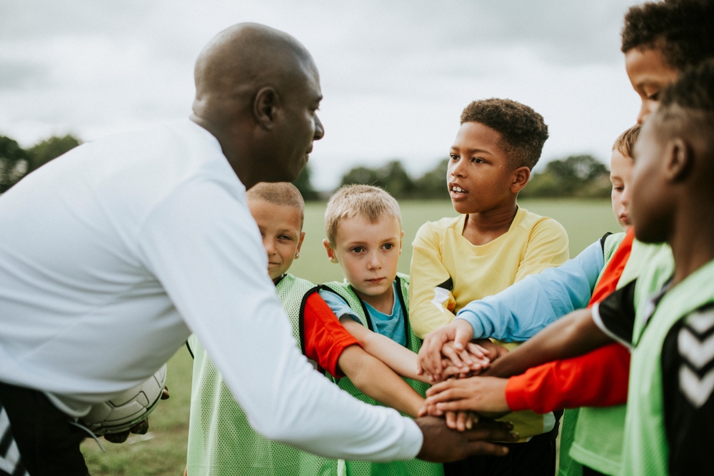 A coach talking to students during a game.