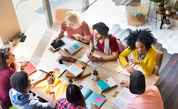 Students in discussion around a meeting table