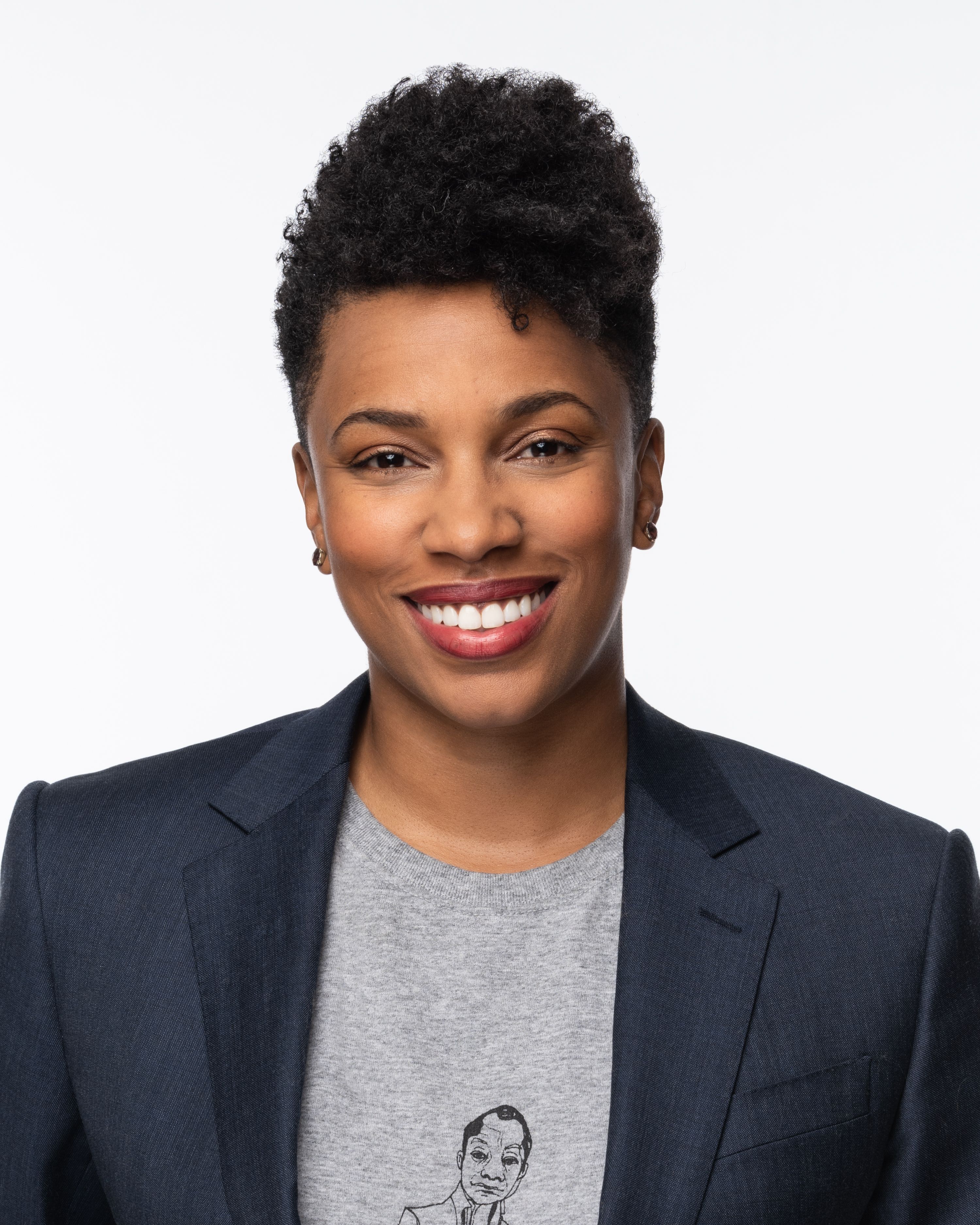 Melanie Willingham-Jaggers headshot. They are wearing a navy blazer and a gray shirt.