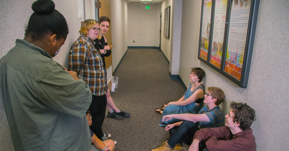 A photo of students in a hallway talking