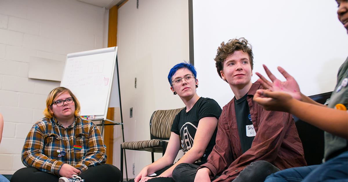 A photo of students in a classroom having a discussion.