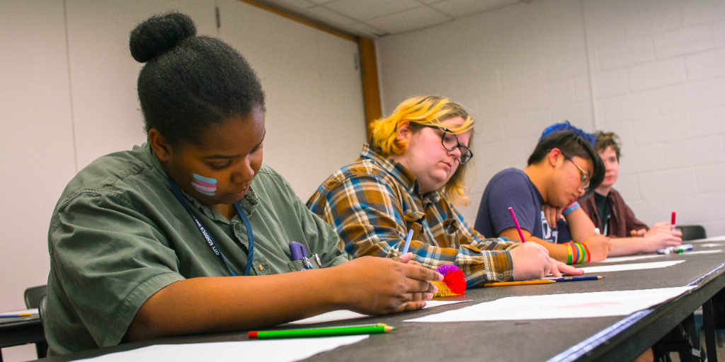 Students in a classroom writing.