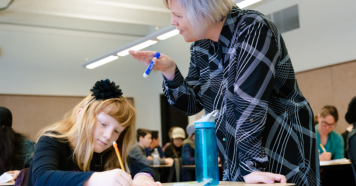 Student and a teacher in a classroom.