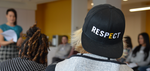 A student with back turned to the camera wearing a GLSEN respect hat.